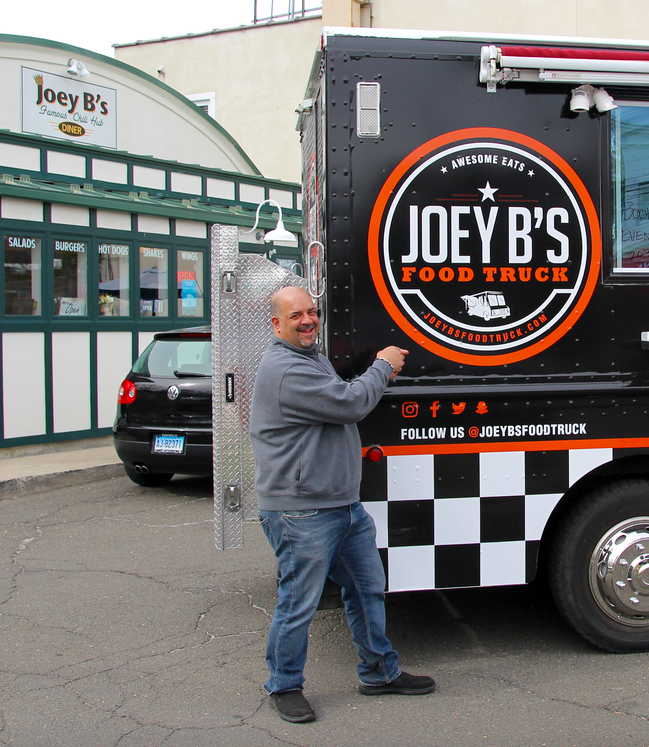 Dom Delfino admiring the logo on the new Joey B\'s Food Truck. Photo Alicia Wolfram. April 24, 2018