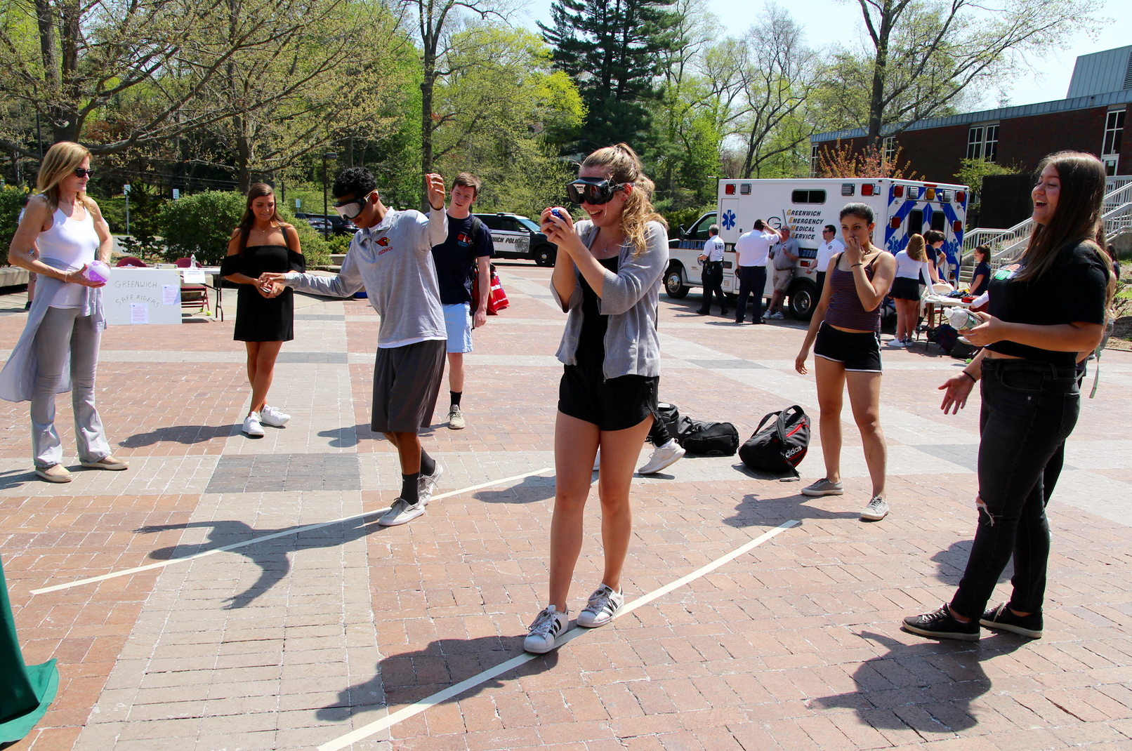 Students at Safe Driving Day worked with Dennis Bludnicki of Liberation Programs to try on goggles and simulate walking a line while drunk or high on marijuana. May 3, 2018 Photo: Leslie Yager