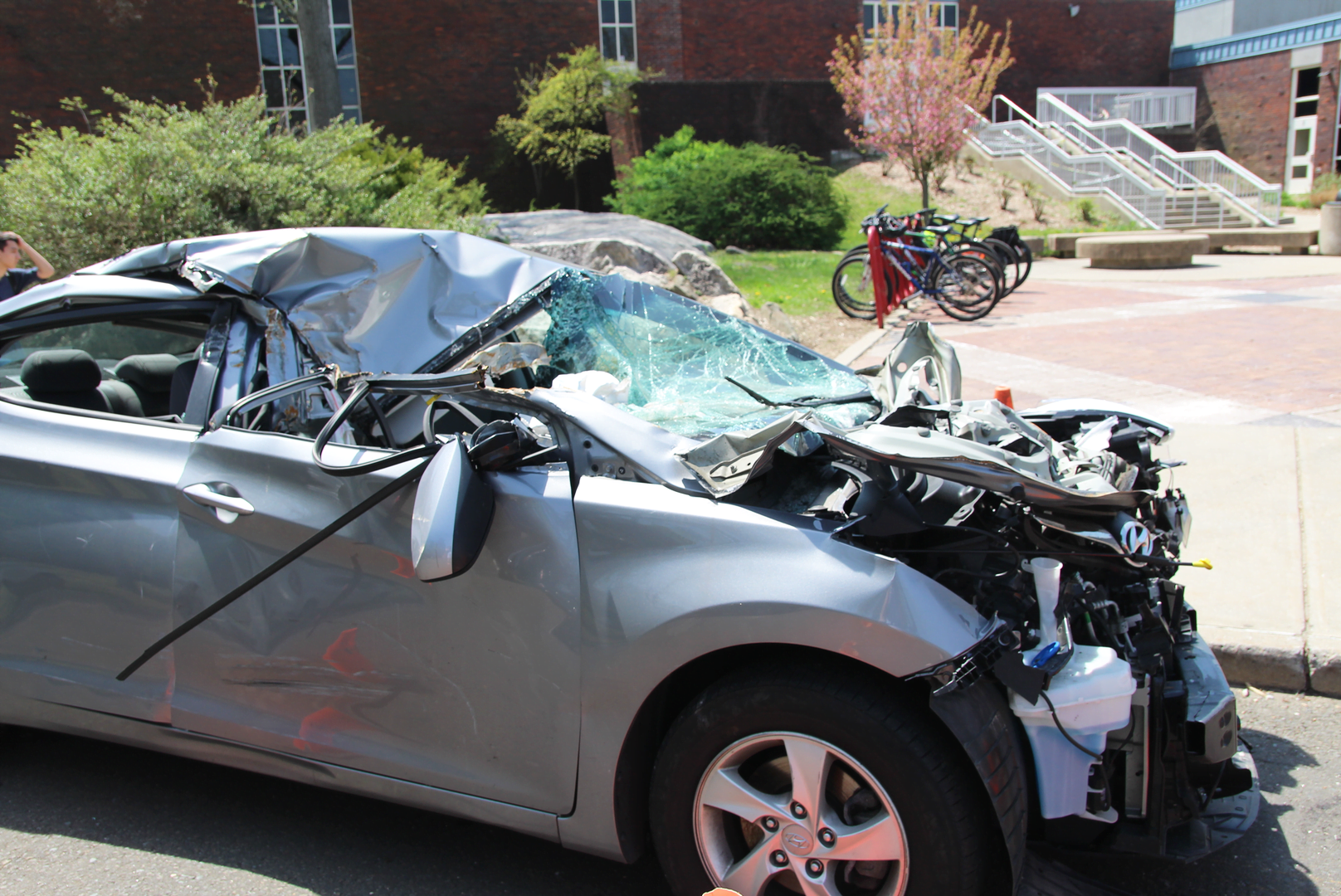 A crashed car in the bus circle at Greenwich High School during Safe Driving Day. May 3, 2018 Photo: Leslie Yager
