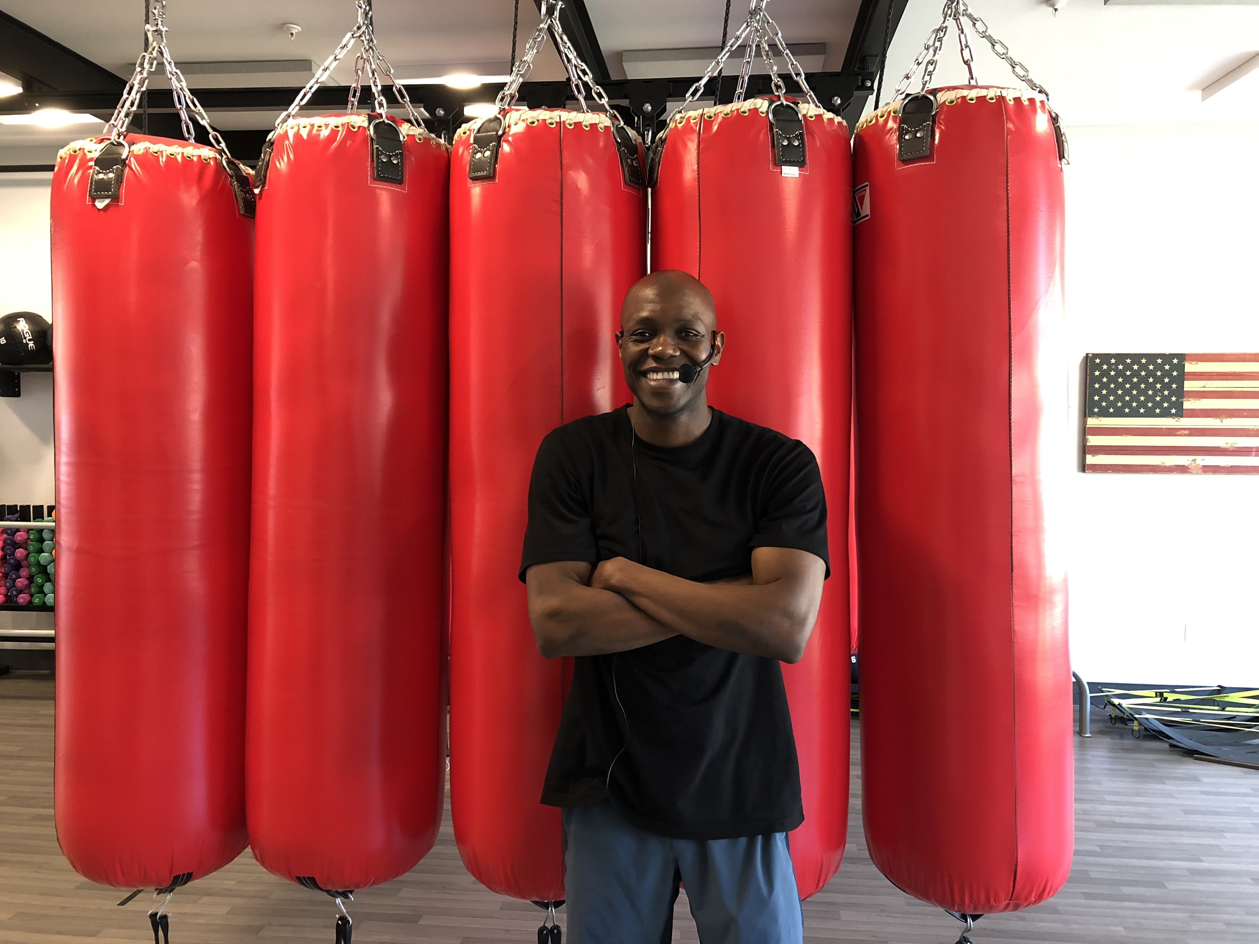 Belly and Body head trainer Jonathan Edmond poses in front of the heavy bags used during most classes. June 14th, 2018. Photo: Omar Merchant.