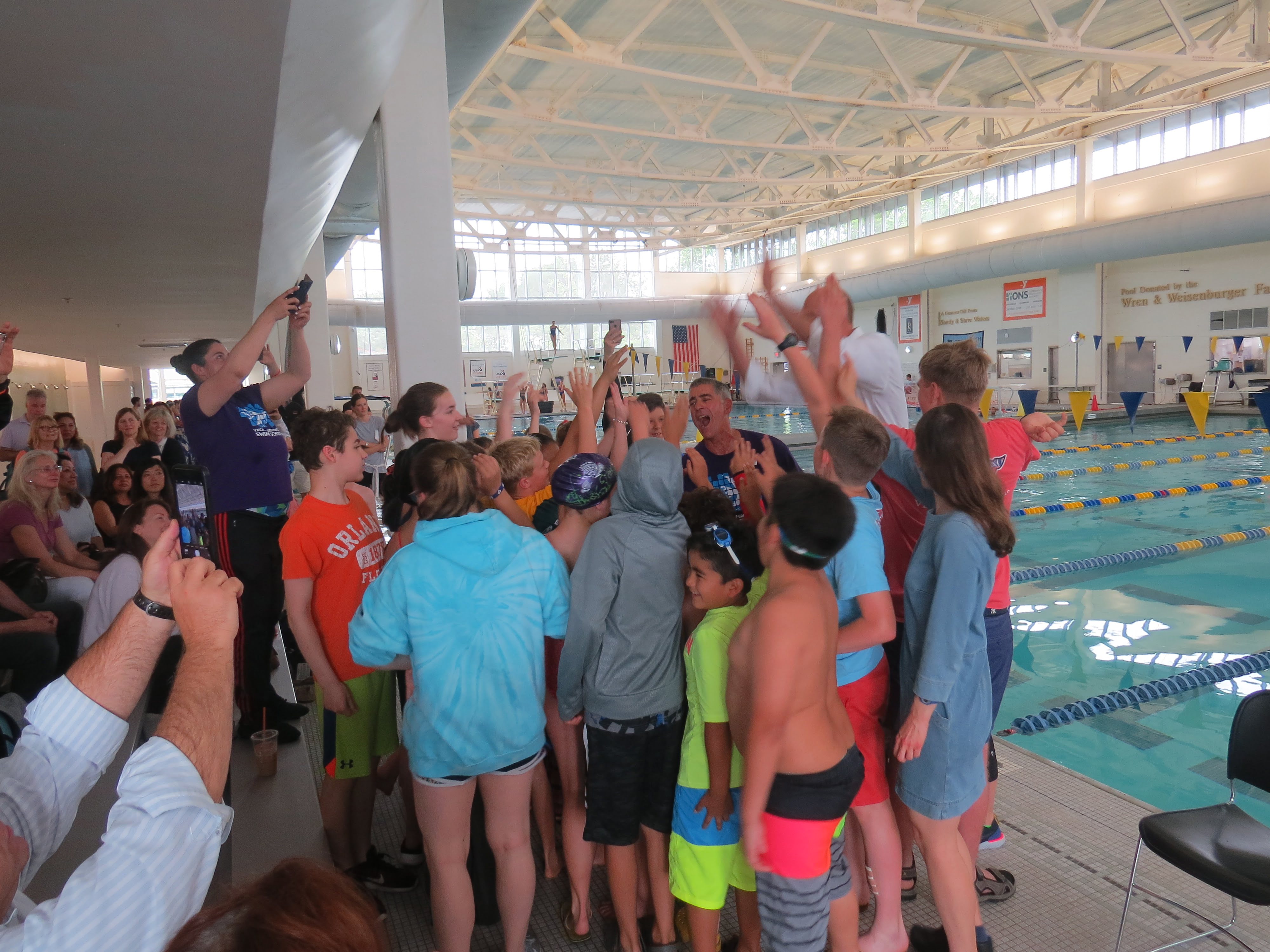 The children prepare for the swim clinic with a cheer. 