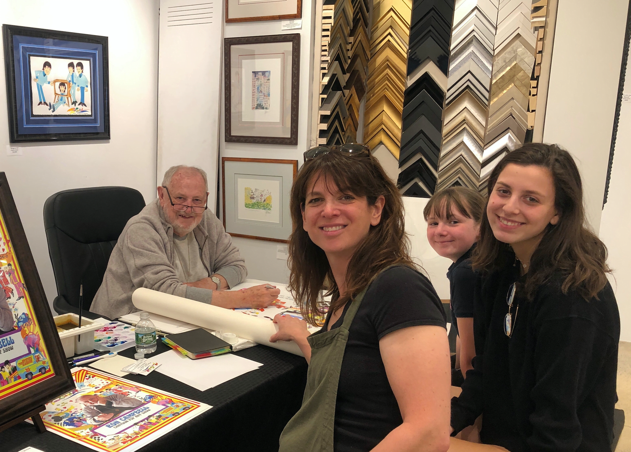 Ron Campbell autographs an original painting with a personalized “childhood memory” for Joli Gross and daughters Ellie and Cami at C. Parker Gallery’s pop art show in Greenwich. Photo: Heather Brown