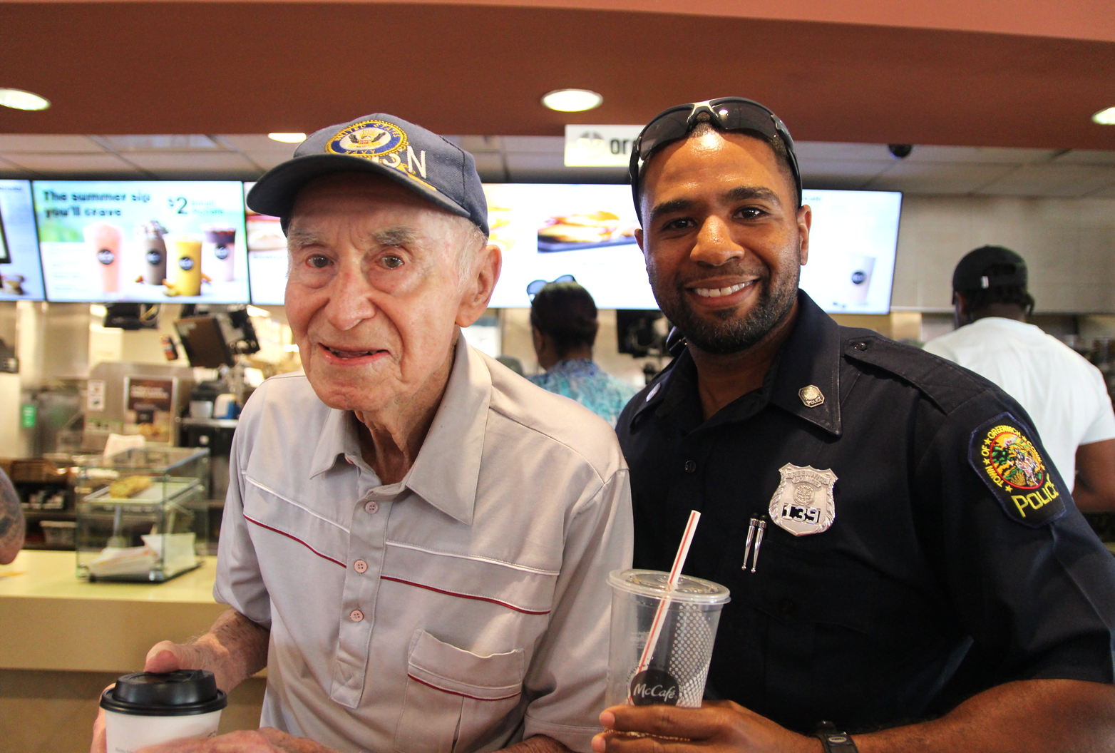 Tony Muskus and Officer Troy Lloyd at the Coffee with a Cop event at McDonald's. July 11, 2018 Photo: Leslie Yager