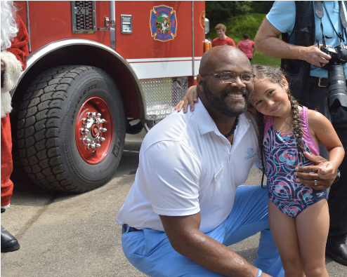 CEO Bobby Walker Jr. and camper Allison Torres smile for the camera after standing under the firehose. Photo by: Alex LaTrenta