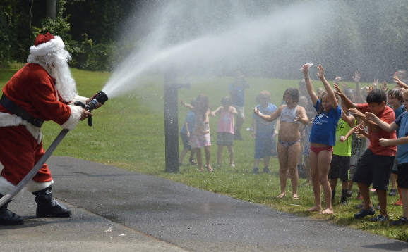 Santa cools down the campers with his firehose. Photo by: Alex LaTrenta