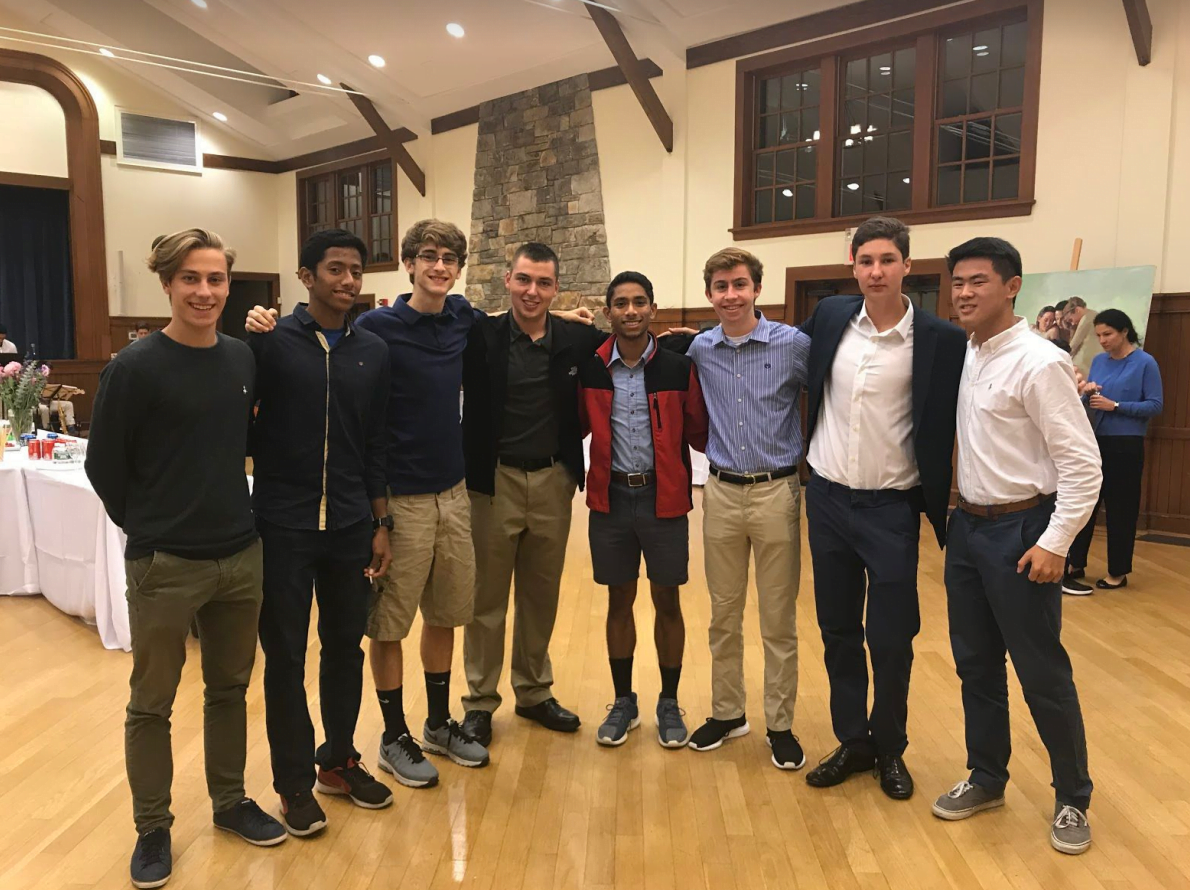 Thomas Ruffiac (on the left) with Aidan Brock and Boris Ardemasov and a group of GHS students who came out to support Art for Awareness at the auction. Contributed photo