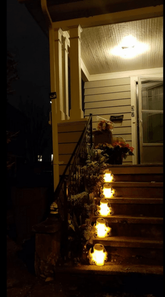 Someone placed flowers and five lanterns in honor of "The Fairfield Five" on the steps of 37 Prince Street in Fairfield where the remains of five dogs were found on November 15.