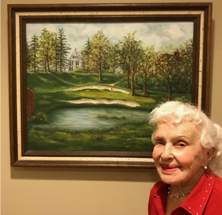 Pat Lee with her Oil Painting of Woodcrest's 18th hole - her childhood home, and father's golf course he built.