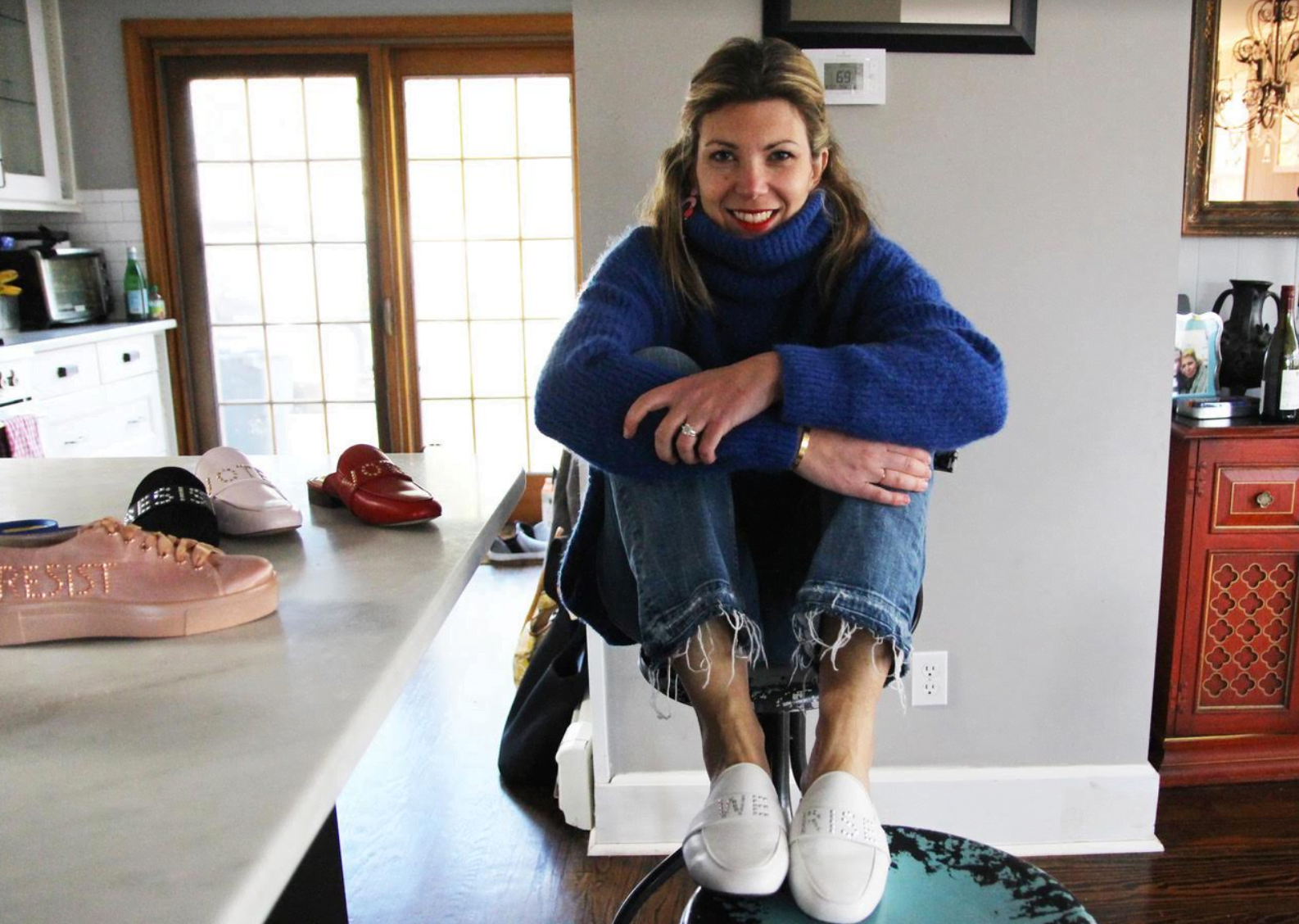 Marina Rosin Levine, one of the co-founders of Indivisible Greenwich, created a line of shoes with messages including Vote, We Rise and Resist. Photo: Leslie Yager