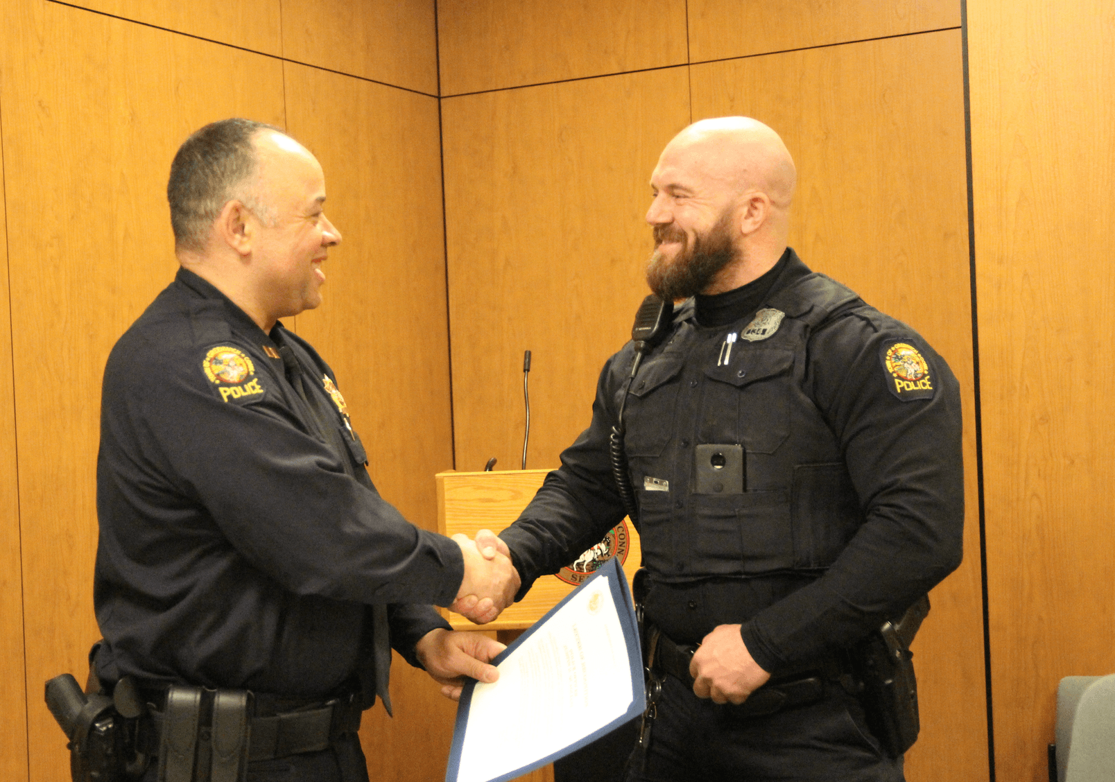 Captain Kraig Gray congratulates Officer Quagliani. Feb 28, 2019 Photo: Leslie Yager