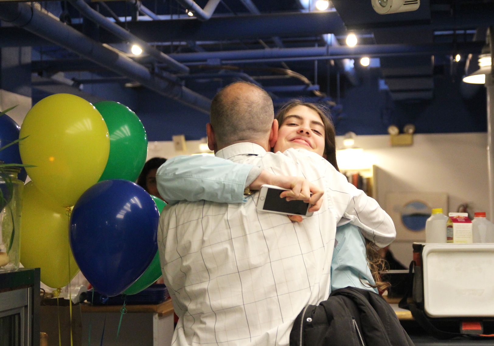 Aria Berger gives Ailton Sousa a hug on his last day operating Elton's Cafe. March 23, 2019 Photo: Leslie Yager