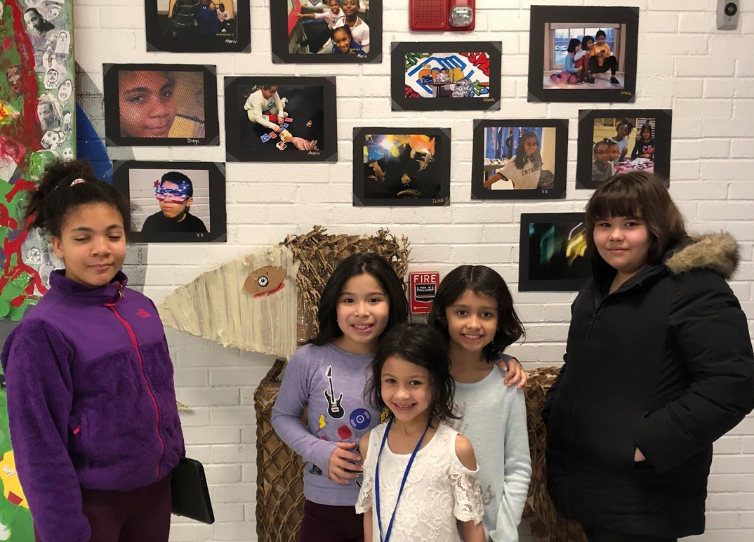 Girl Scout Gold Award candidate Anna Meurer brings her passion for photography to the Greenwich Boys and Girls Club with her "Introduction to Photography" course. Here, participants in her class hang some of their work around the Club for their final showcase. Photo: Anna Meurer