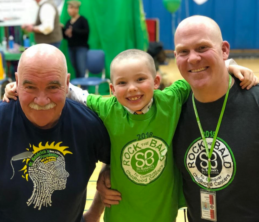 Kerry Gavin, event organizer, with his son Dylan and father-in-law John B Verrier, has shaved his head for the past sixteen years at his annual St. Baldrick's event.