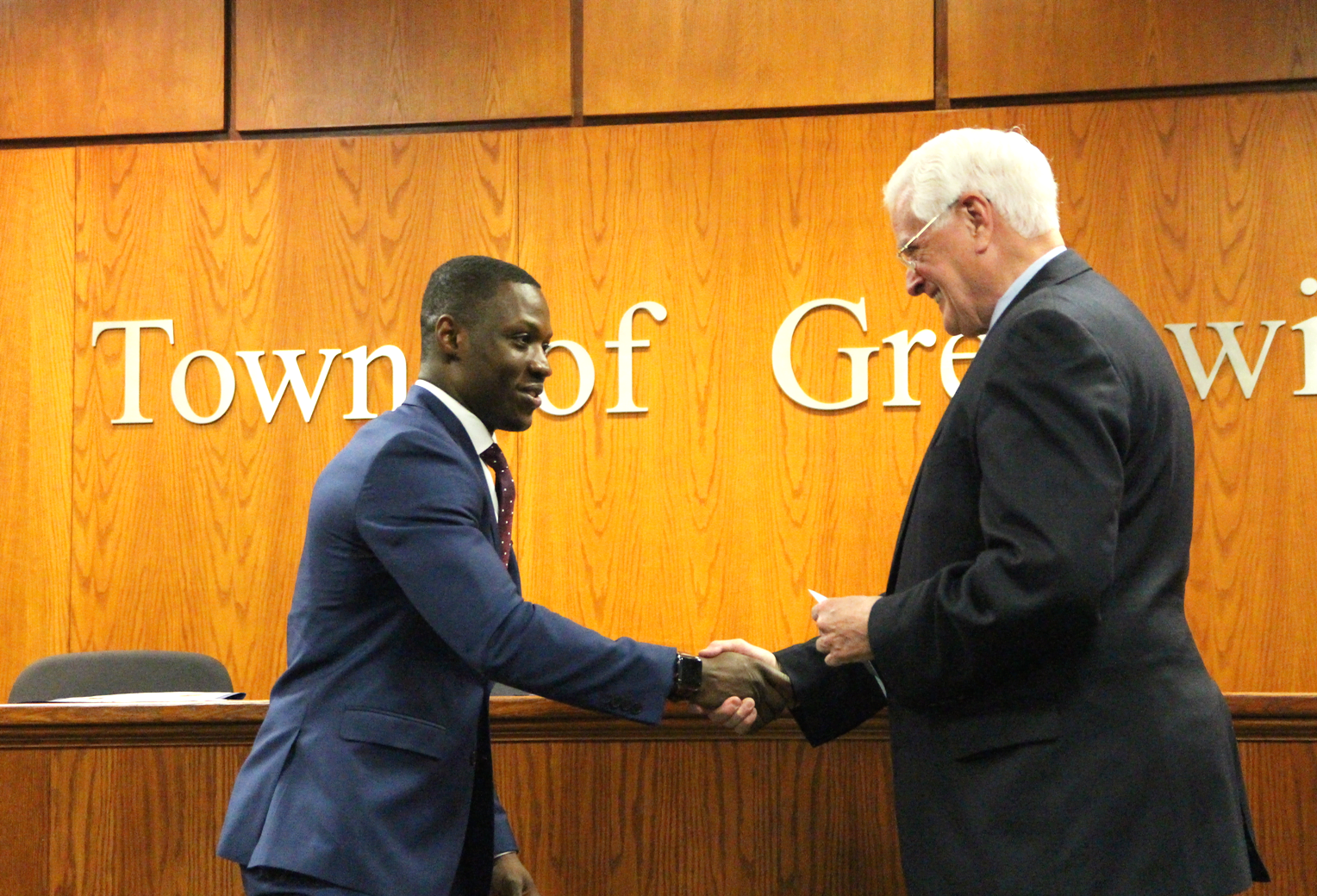 Newly sworn in Officer Vladimir Souffrant is congratulated by Selectman John Toner. April 1, 2019 Photo: Leslie Yager