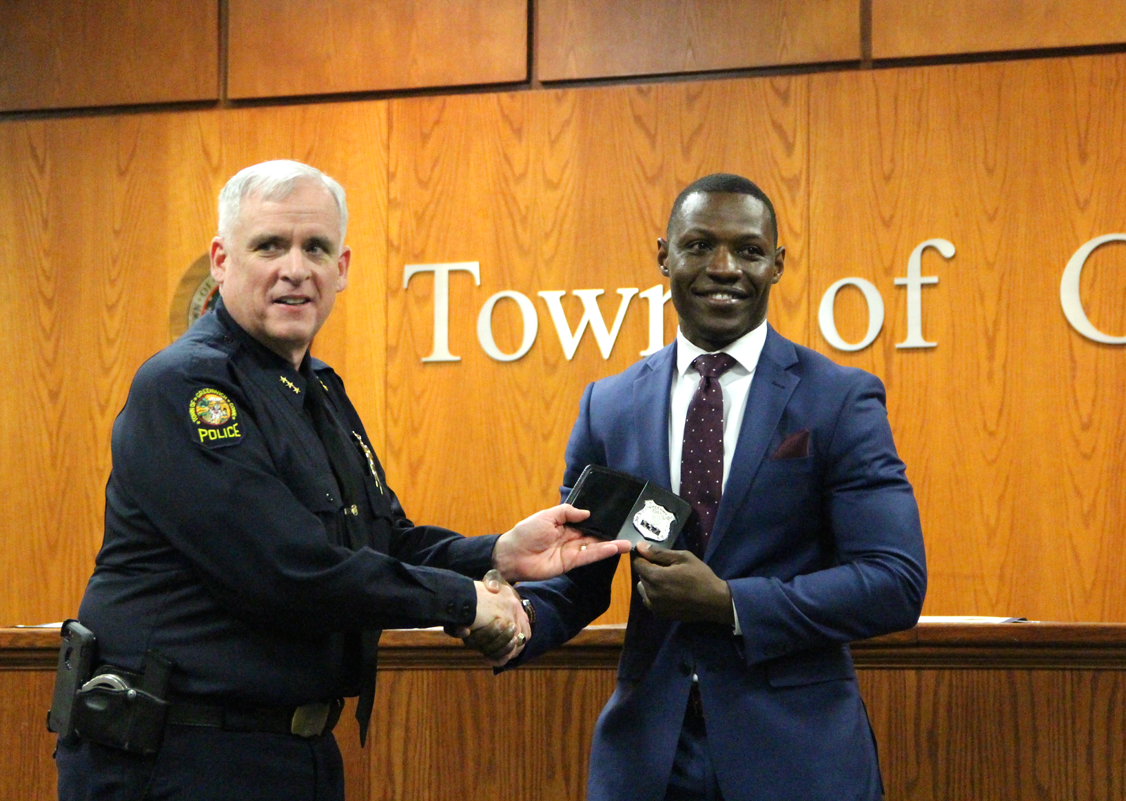 Newly sworn in Officer Vladimir Souffrant receives his badge from Greenwich Police Chief Jim Heavey. April 1, 2019 Photo: Leslie Yager
