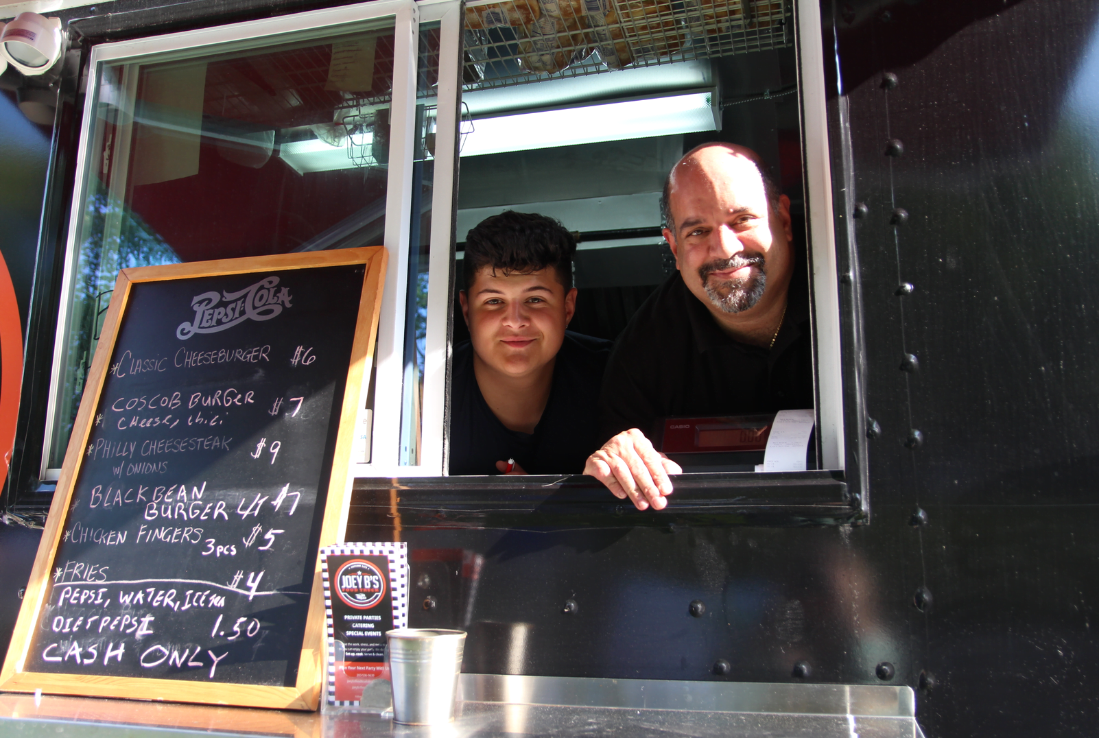Domenick Delino and his father Dom Delfino took orders in their Joey B's Food Truck at the Boys & Girls Club. May 19, 2019 Photo: Leslie Yager