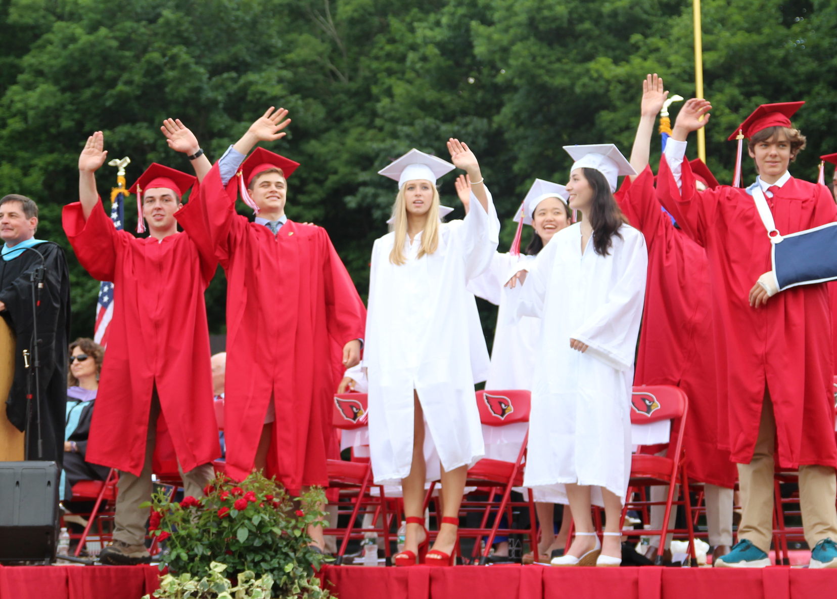 Leaders of the class of 2019 on the podium wave to their classmates and families at graduation. June 17, 2019 Photo: Leslie Yager