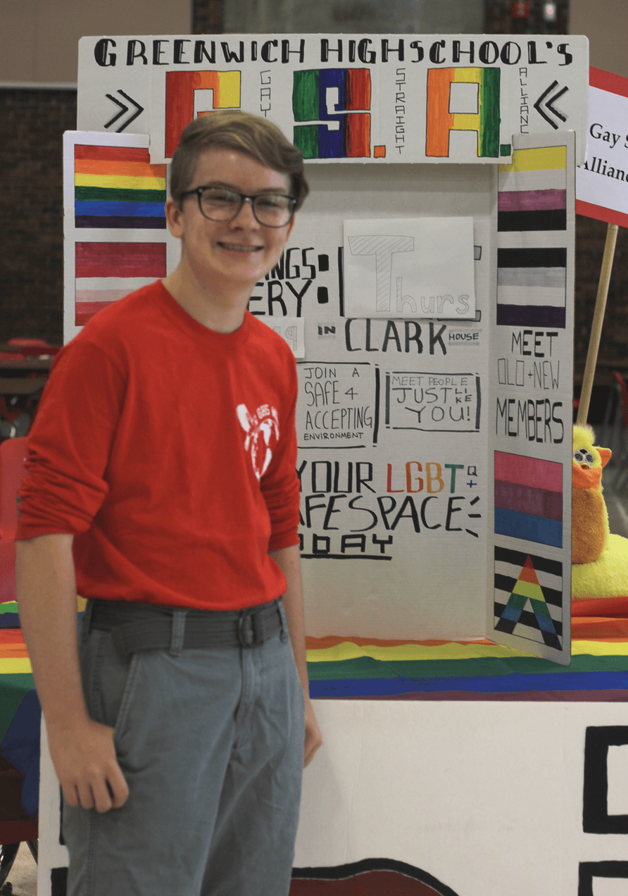 Skyler McDonnell standing in front of the Gender and Sexuality Alliance poster. Photo: Jordan Paris