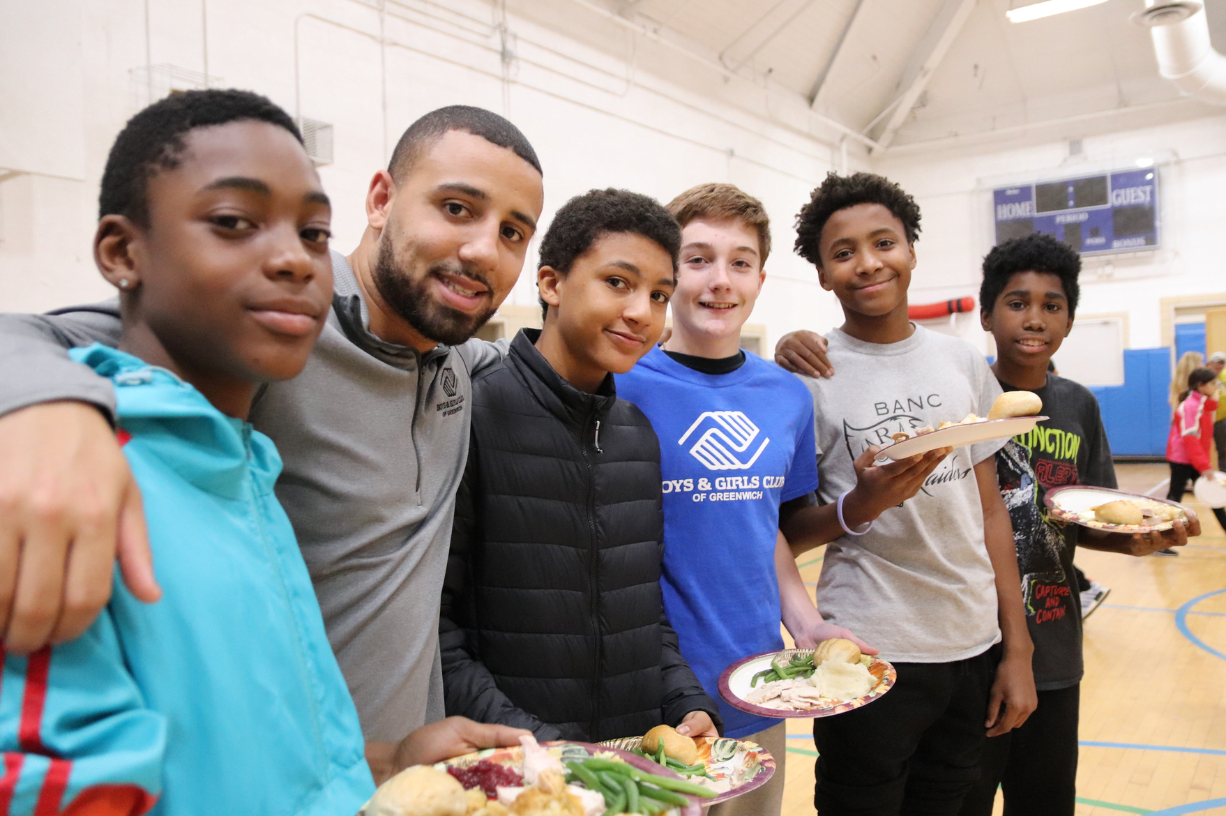 The Boys & Girls Club of Greenwich club coordinator Camry Ferrara with Club kids at 17th annual Thanksgiving dinner on Nov 26, 2019 Photo: Leslie Yager