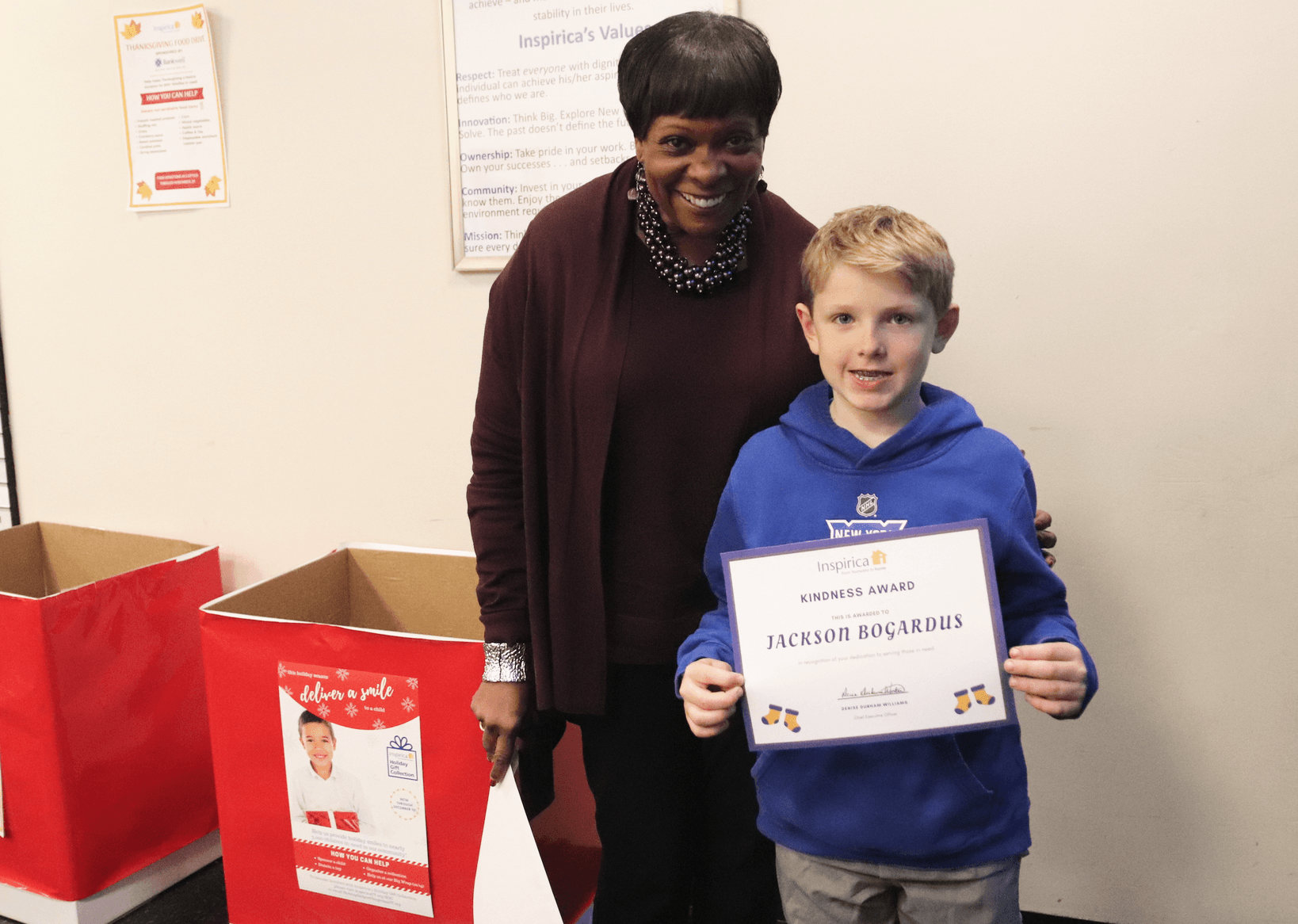 Jackson Bogardus was recently presented a Kindness Award by Inspirica CEO Denise Durham Williams in Stamford for his successful "Socktober" sock drive in Greenwich. Photo: Leslie Yager