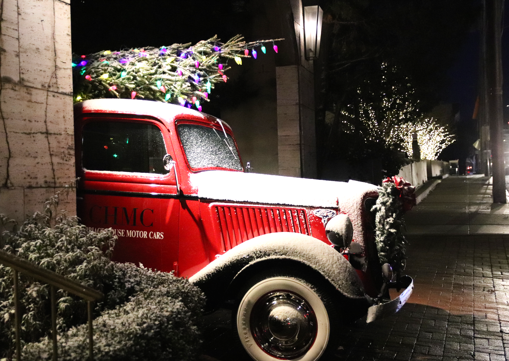 Dusted with snow, a vintage car at Carriage House Motor Cars on Railroad Ave is topped with a Christmas tree speckled with colorful lights. Dec 17, 2019 Photo: Leslie Yager