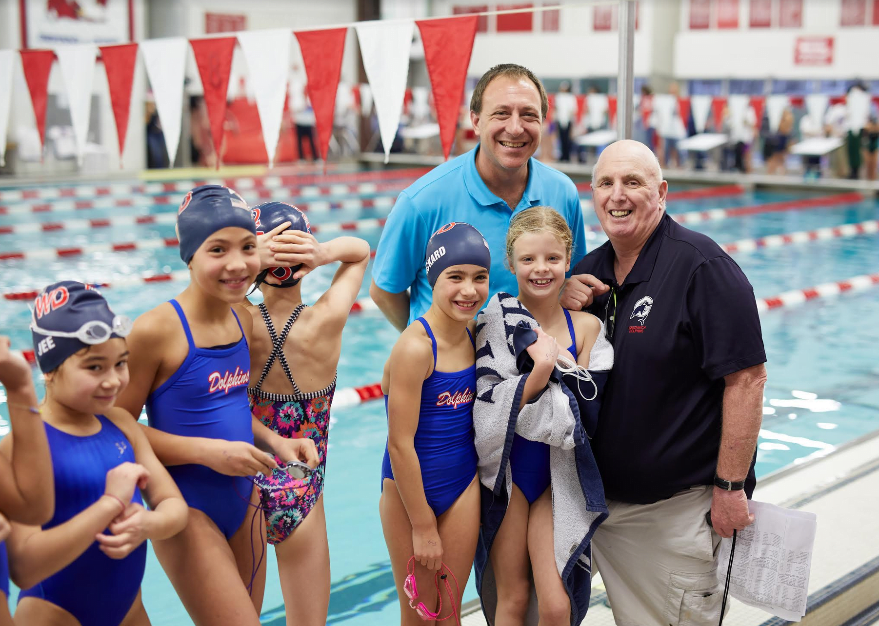Coach Nick Cavataro and David Fine with Dolphins Swimmers. Contributed photo