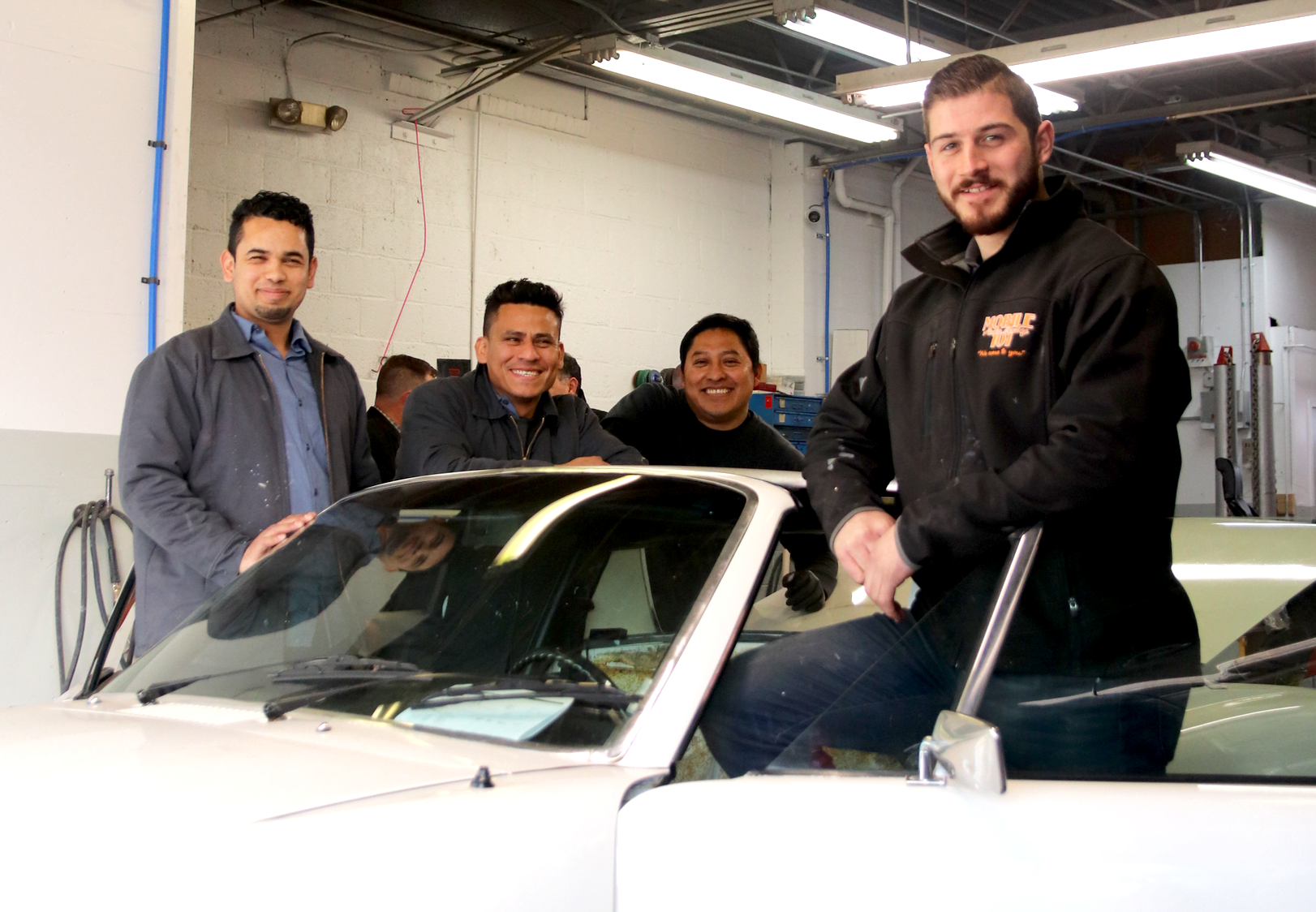 John Castellana Jr and some of his auto technicians at 368 West Ave in Stamford. Jan 21, 2020. Photo: Leslie Yager