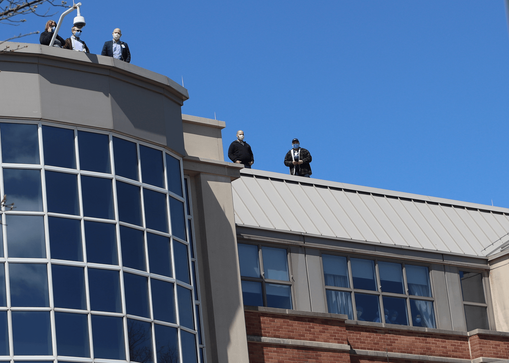 Hospital staff on the roof and peering out the windows of Greenwich Hospital. April 15, 2020 Photo: Leslie Yager